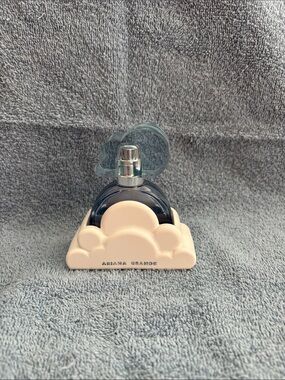 Ariana Grande cream cloud perfume stand with blue bottle